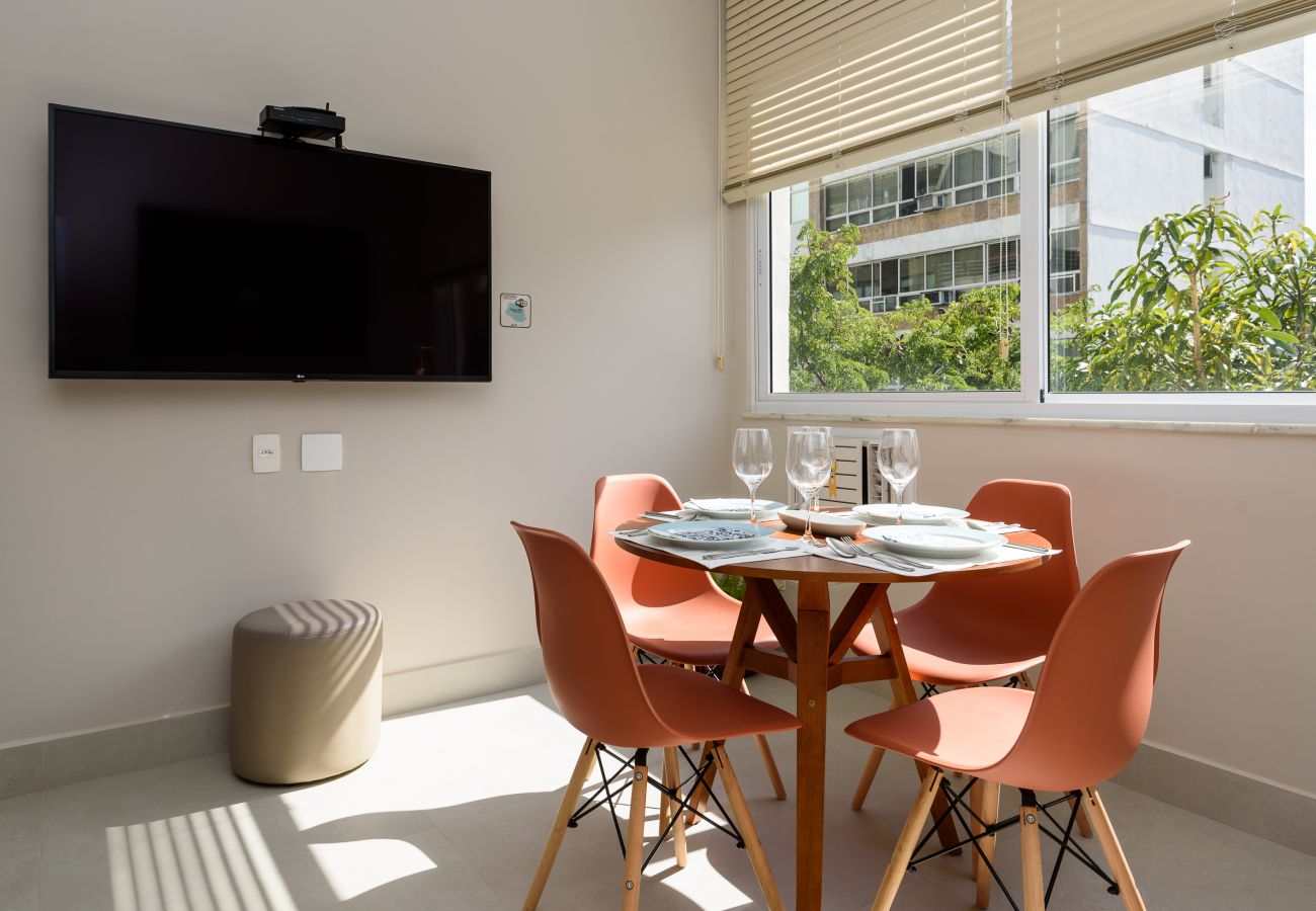 Dining room with dining table and TV.